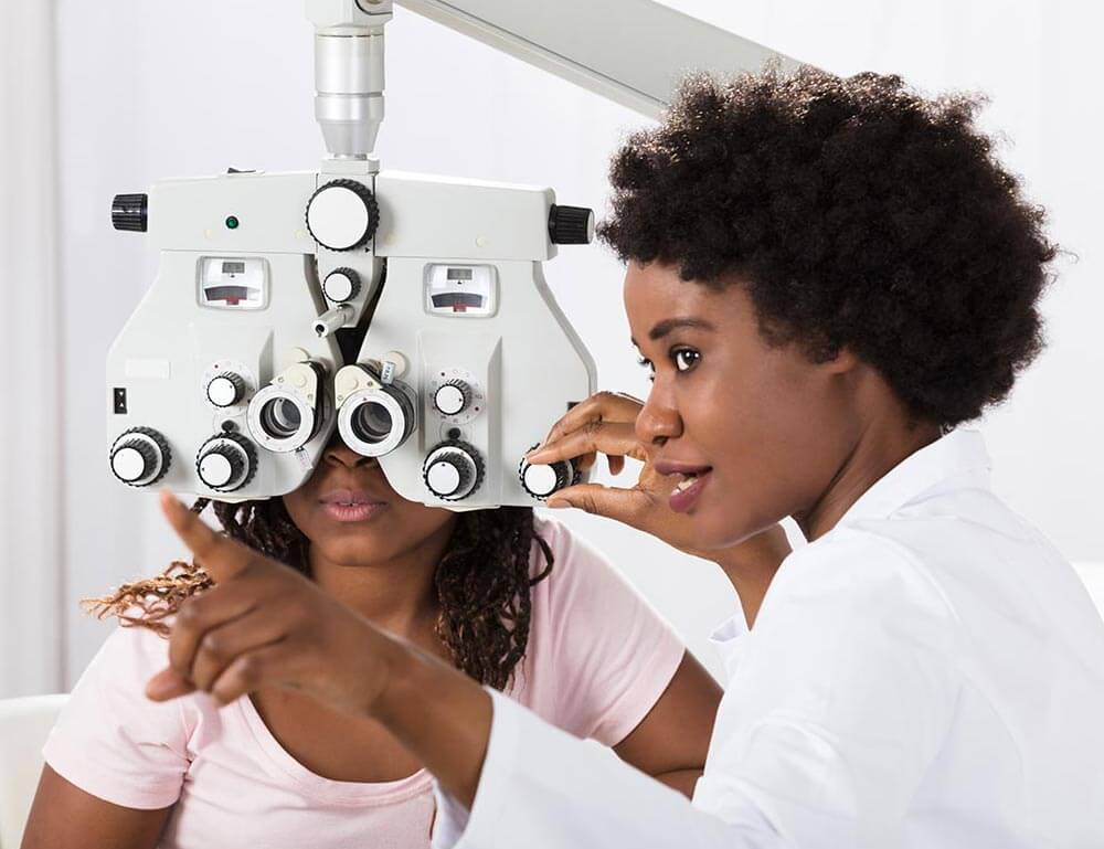 Optometrist working with a patient