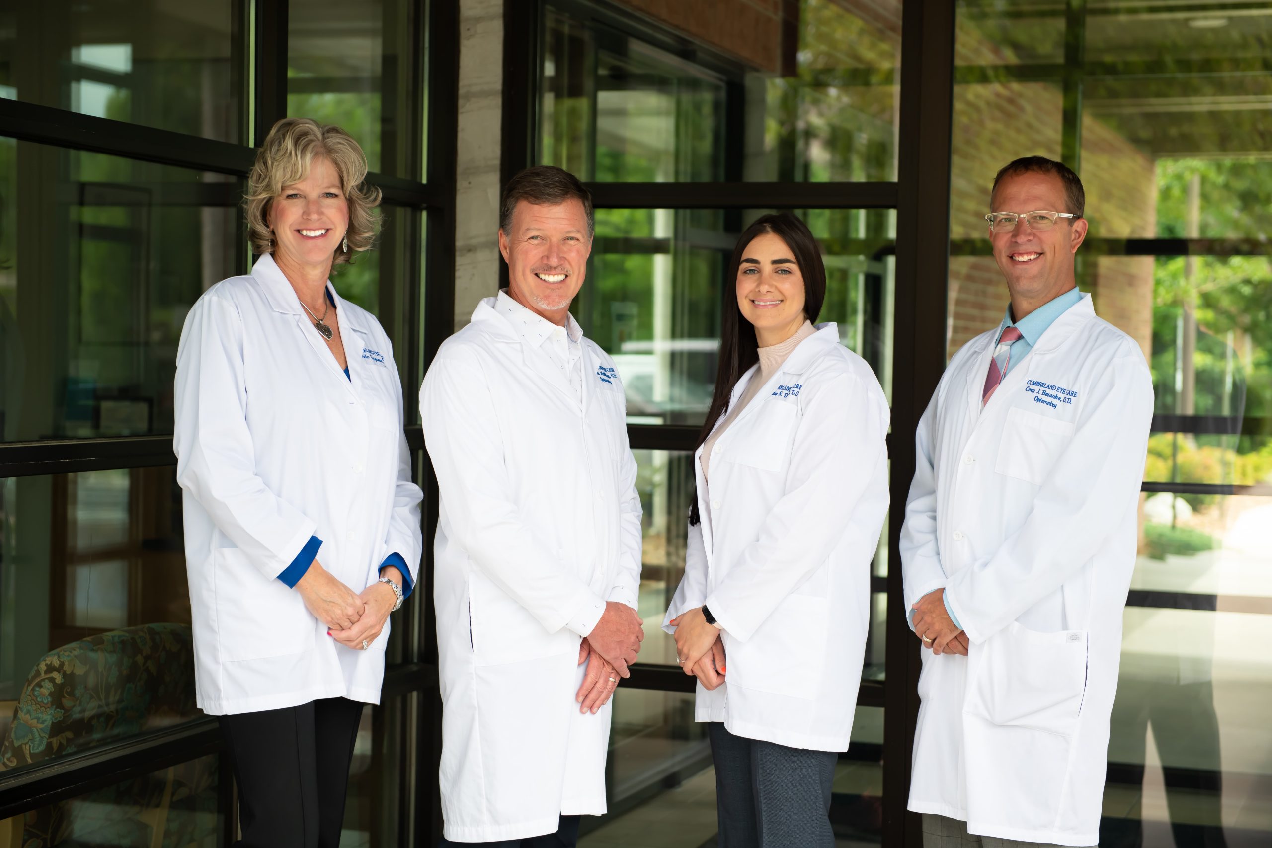 All of the Cumberland Eye Doctors standing together in their uniform smiling at the camera