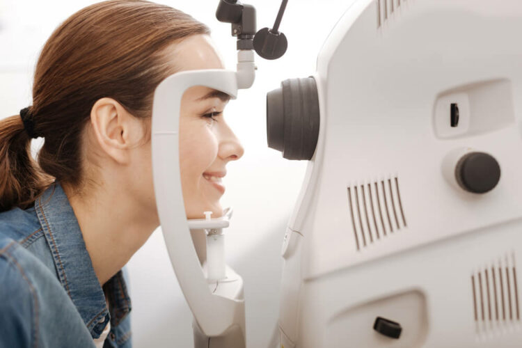 Smiling woman taking eye exam