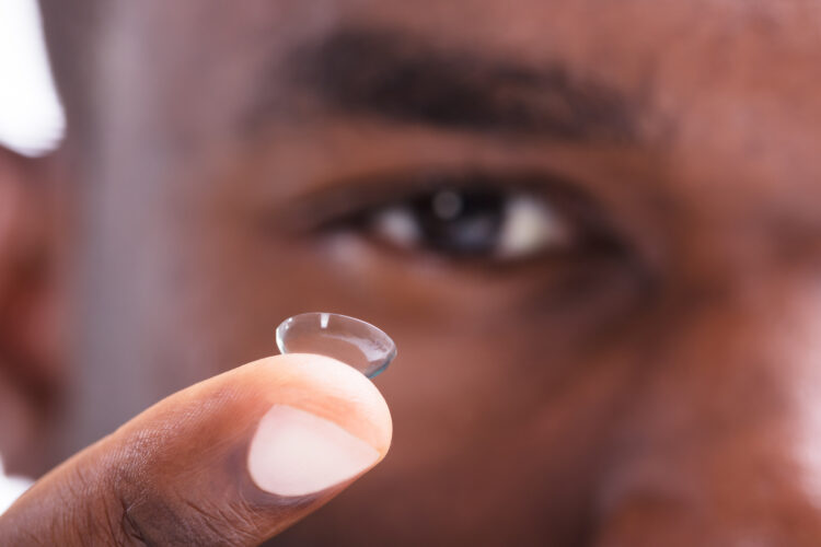 Man holding a contact up to the camera