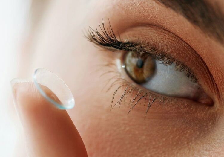 Close up of woman putting in a contact lens