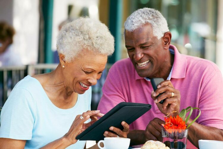 Older couple looking smiling while having coffee