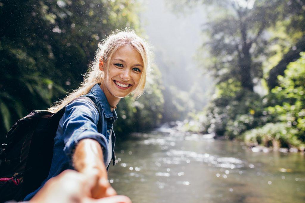 Young girl smiling walking through a river